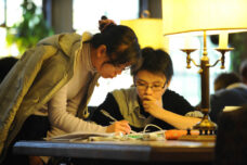 International students work on econometrics classwork together in the study room at the Michigan Union.