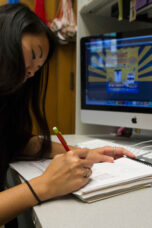 A student works on a sketch for an advertisement.