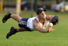 A member of the men's intramural softball team, "The Bambinos," dives at a line drive hit during a game at Elbel Field.