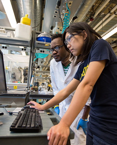 Faculty and students collaborate at an electrochemical workstation in the Phoenix Memorial Lab