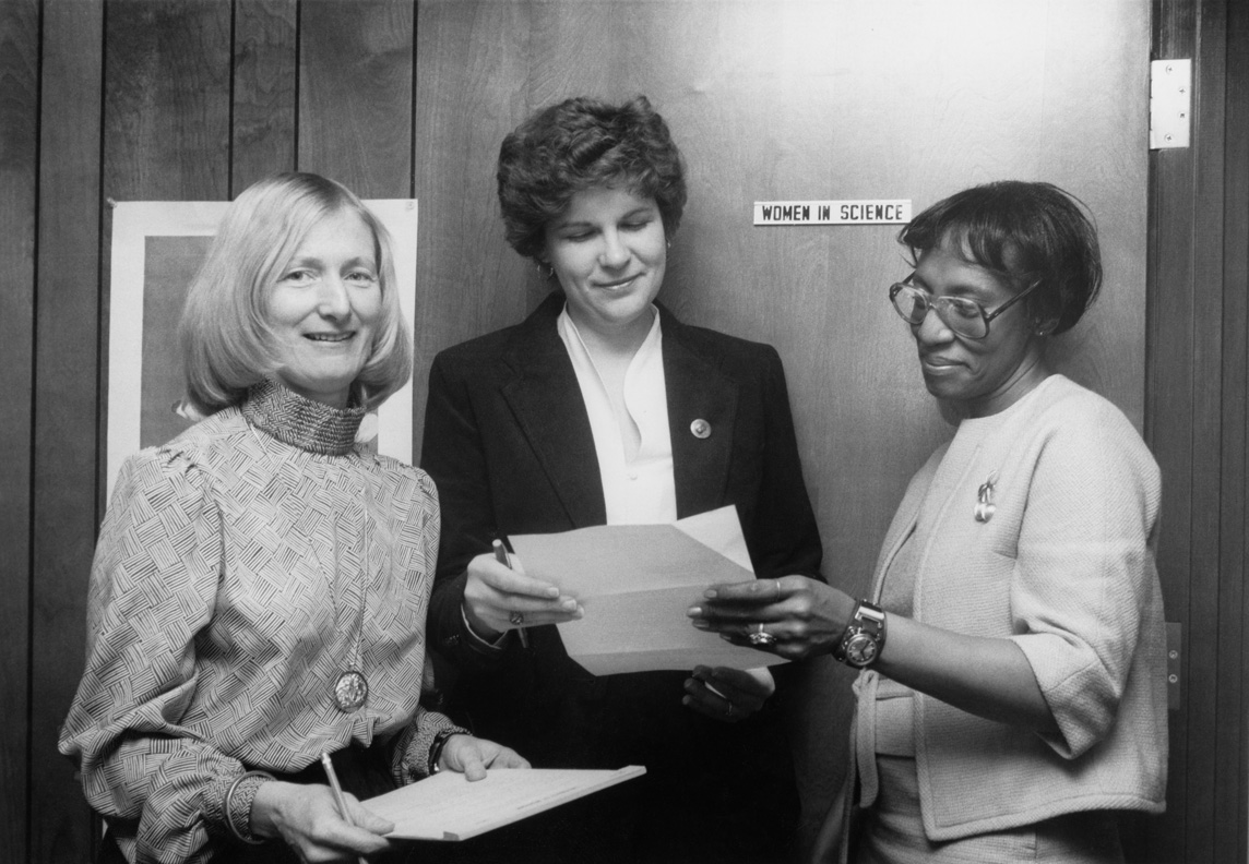 Left to right: Barbara Sloat, Sally Dunnick (WIS Program Assistant), and Addie Hunter (CEW/WIS Secretary) at the Women In Science office at Center for the Education of Women, 1983