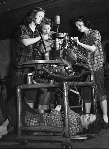 Engineering students rebuilding an engine, circa 1945
